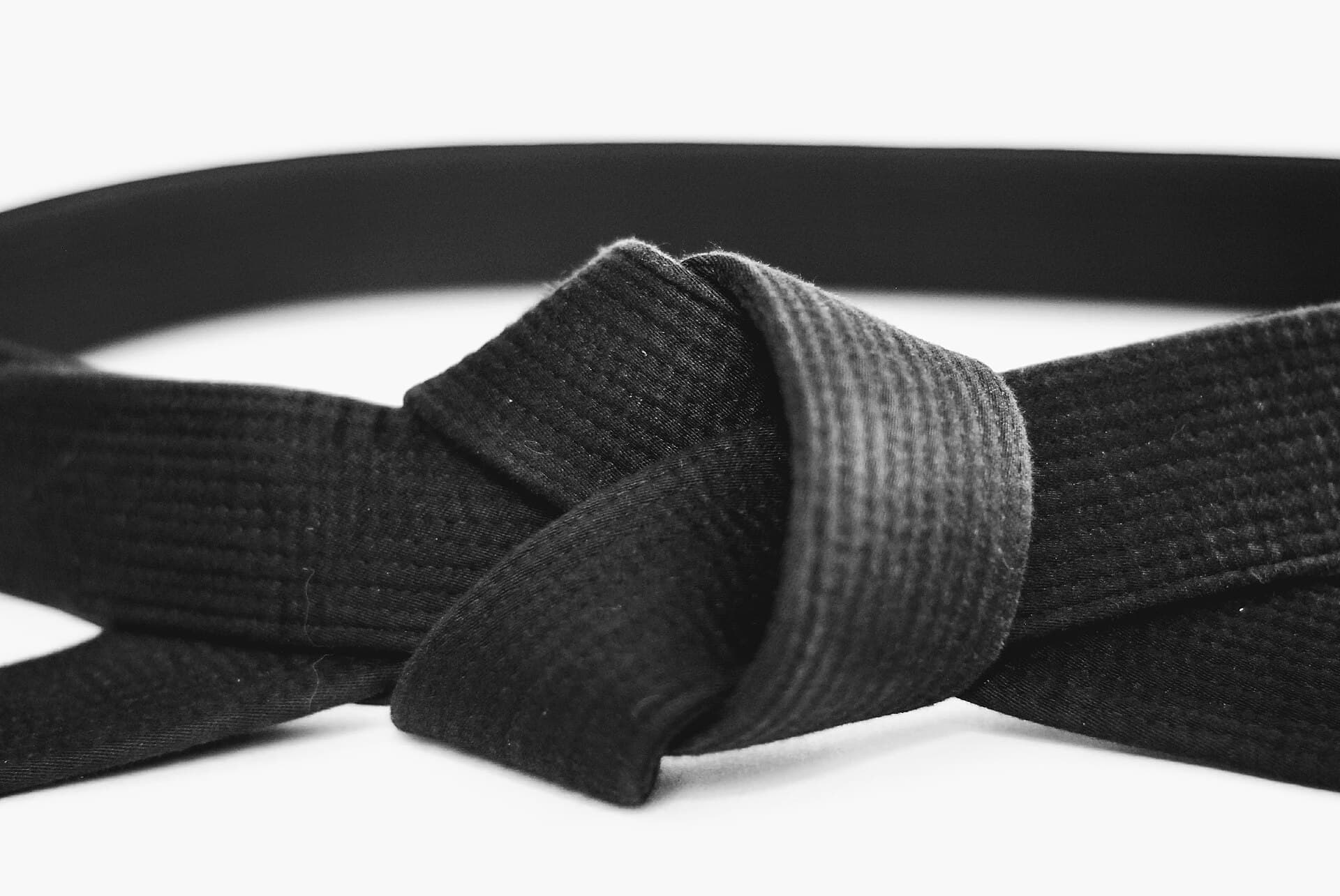 Close detail of a tied black belt after training.